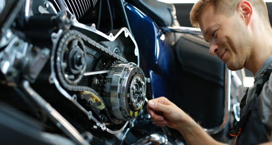happy mechanic fixing motorcycle