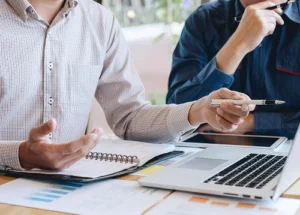 two individuals strategizing a plan