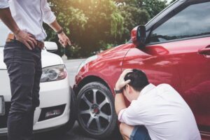 Two drivers man arguing after a car traffic car fender bender accident 